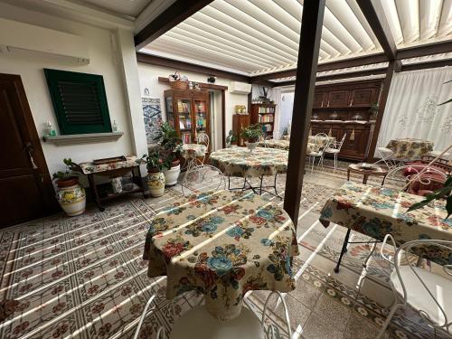 a room with tables and chairs in a building at Domus Socolatae Residenza d'Epoca Charming B&B - Adults Only in Follonica