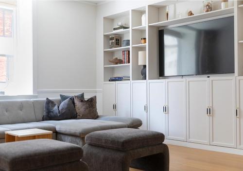 a living room with a couch and a flat screen tv at Central City Apartment in Copenhagen in Copenhagen