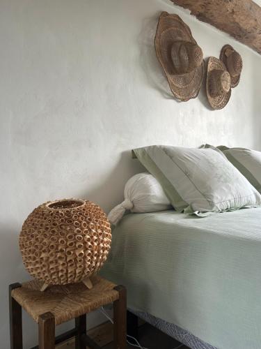 a bedroom with a bed and a table with a basket at Chambres d'Hôtes Manoir Du Chêne in Nonant
