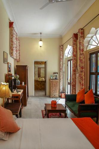 a living room with a couch and a table at Diggi Palace - A City Center Hidden Heritage Gem in Jaipur
