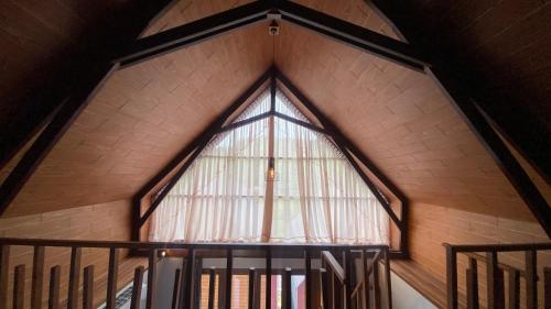 a large window in a church with a spiral staircase at Drini Hills Diamond Villa in Brono