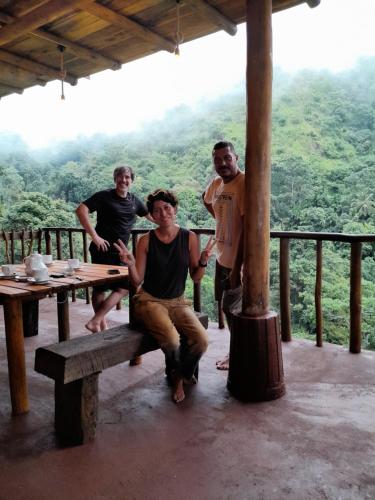 a group of men sitting on a bench on a table at Wood Palace Ella in Ella