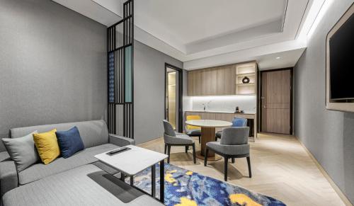 a living room with a couch and a table at Hyatt Place Makassar in Makassar