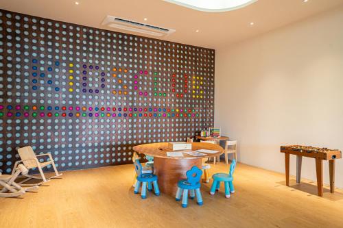 a room with a ping pong table and chairs at Barcelo Coconut Island, Phuket in Phuket Town