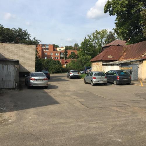a group of cars parked in a parking lot at Hostel Filaretai in Vilnius