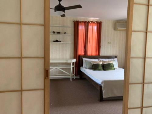 a bedroom with a bed and a window and a bed sidx sidx sidx at Cozy Family Home near Nuvali & Tagaytay with wifi in Santa Rosa