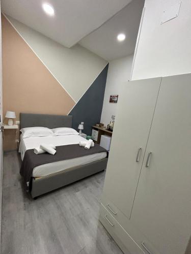 a bedroom with a large bed with white sheets at Garibaldi guest house in Naples