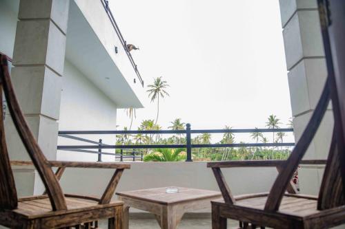 two chairs and a table on a balcony at Hirigala Beach Resort in Ahangama