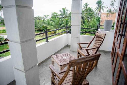 two chairs and a table on a balcony at Hirigala Beach Resort in Ahangama