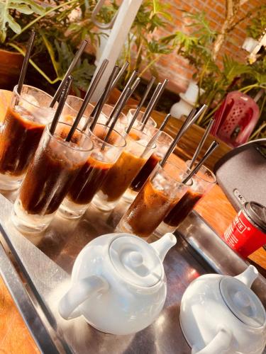 a group of glasses of iced coffee and a tea kettle at White Villa Đà Lạt in Da Lat