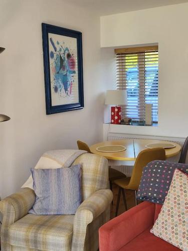 a living room with a couch and a table and chairs at The Wee House - An Teach Beag in Falcarragh