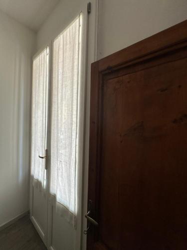 a door in a room with a window at Domus Socolatae Residenza d'Epoca Charming B&B - Adults Only in Follonica