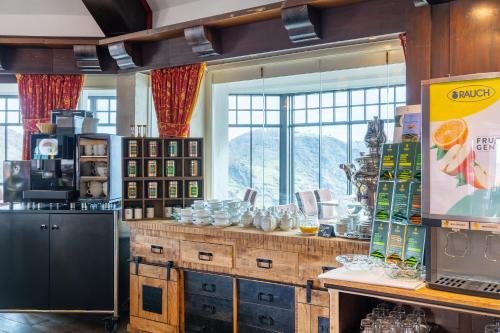 a kitchen with a large window and a counter at Hotel Schloss Rheinfels in Sankt Goar