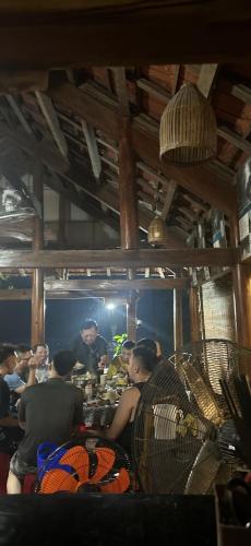 a group of people in a kitchen preparing food at Son River House in Phong Nha