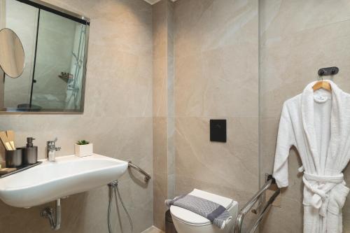 a bathroom with a sink and a toilet at Elia Sea Suites in Chania Town
