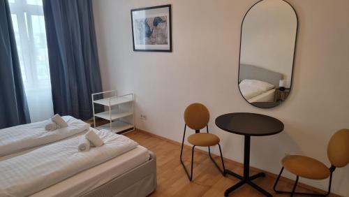 a small bedroom with a bed and a mirror at Allinone in Klosterneuburg
