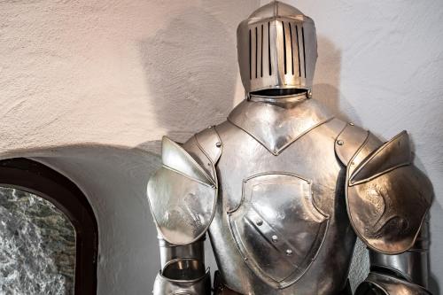 a metal knight is standing next to a wall at Hotel Schloss Rheinfels in Sankt Goar