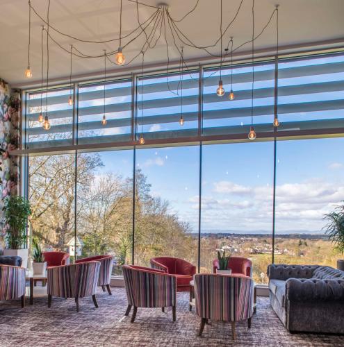 a room with a large window with chairs and a couch at DoubleTree by Hilton Bristol South - Cadbury House in Yatton