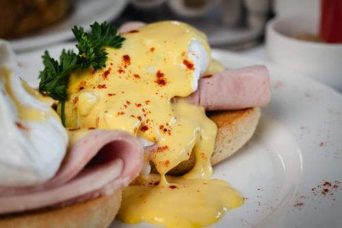 an egg sandwich with ham and cheese on a plate at DoubleTree by Hilton Bristol South - Cadbury House in Yatton