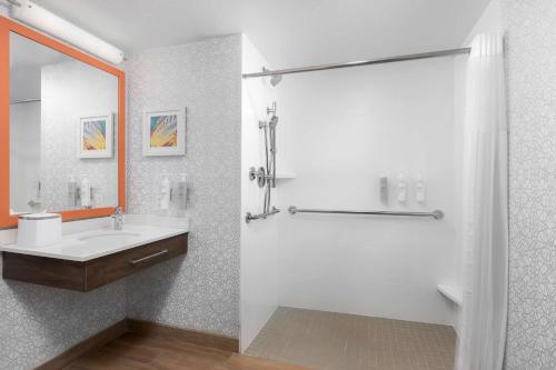 a white bathroom with a sink and a shower at Hampton Inn Louisville Airport Fair/Expo Center in Louisville