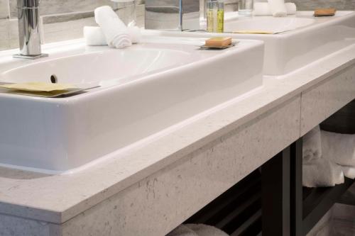 a white sink in a bathroom at DoubleTree by Hilton Bristol South - Cadbury House in Yatton