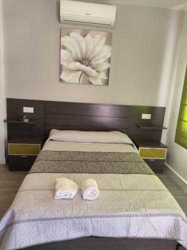 a bedroom with a bed with two towels on it at LA GARRUCHa in Argamasilla de Alba