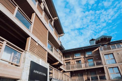 an apartment building with a sign on the side of it at Annapurna by Alpine Resorts in Les Gets