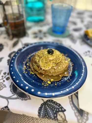 a blue plate with a pancake on a table at Aurora Boutique Hotel - Only Adults in Marbella