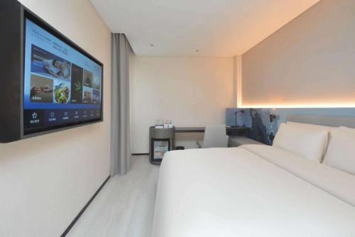 Ένα ή περισσότερα κρεβάτια σε δωμάτιο στο Atour Light Hotel Nanjing South Railway Station South Square