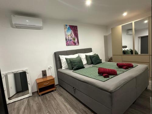 a bedroom with a bed with two red stuffed animals on it at Villa Erwin with heated pool in Imotski