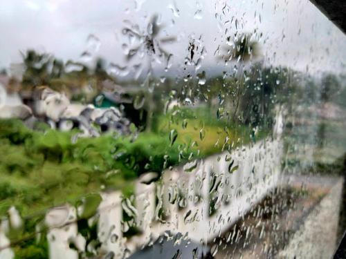 a view of a window with rain drops on it at JK Home stay in Sultan Bathery