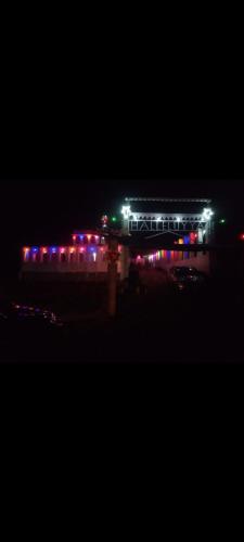 a train station lit up at night with lights at JK Home stay in Sultan Bathery