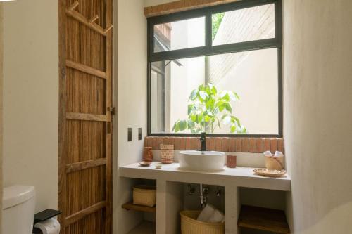a bathroom with a sink and a window at Aymara Punta Zicatela in Brisas de Zicatela