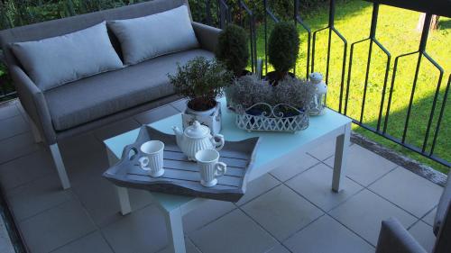 a couch and a table with plants on a patio at Provenzale in Desenzano del Garda