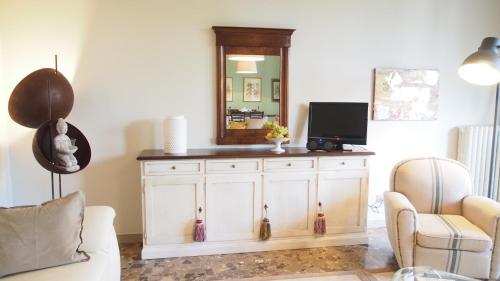 a living room with a mirror and a white cabinet at Provenzale in Desenzano del Garda