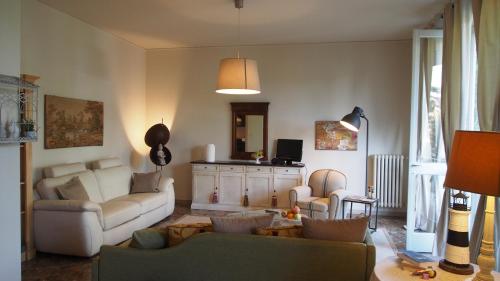a living room with a couch and two chairs at Provenzale in Desenzano del Garda