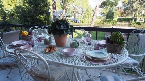 a white table with a plate of food on it at Provenzale in Desenzano del Garda