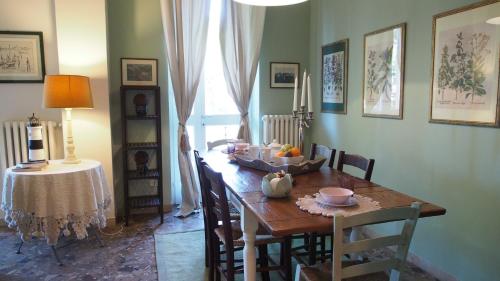 a dining room with a wooden table and chairs at Provenzale in Desenzano del Garda