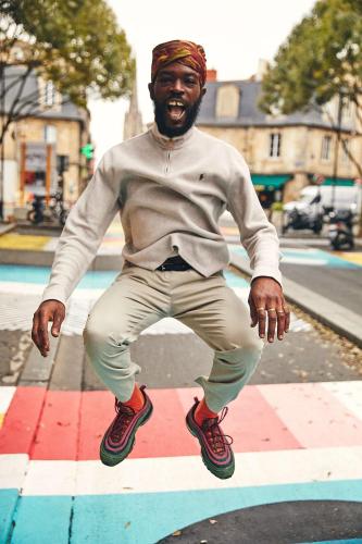 a man jumping in the air on a sidewalk at FirstName Bordeaux, Part of JdV by Hyatt in Bordeaux