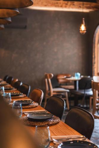 a long wooden table in a restaurant with chairs at Ona Lomas Village - La Manga Club in La Manga del Mar Menor