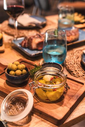 a wooden table with food and a glass jar of food at Ona Lomas Village - La Manga Club in La Manga del Mar Menor