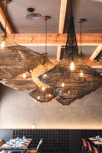 a group of chandeliers hanging from the ceiling of a restaurant at Ona Lomas Village - La Manga Club in La Manga del Mar Menor