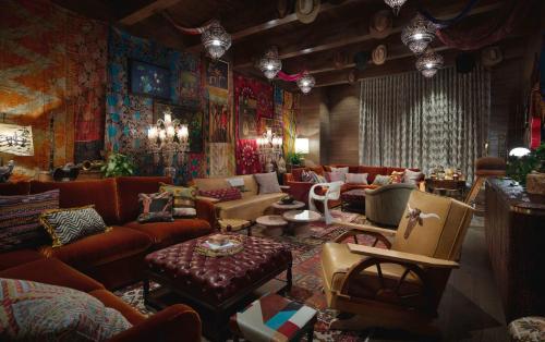 a living room with red couches and a room with colorful walls at Graduate by Hilton Nashville in Nashville