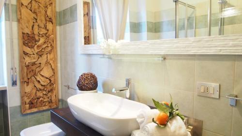 a bathroom with a white sink and a mirror at Provenzale in Desenzano del Garda