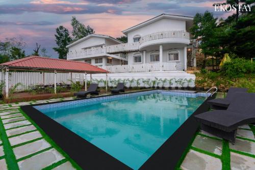 a house with a swimming pool in front of it at EKOSTAY Gold - White Swan Villa 6BHK in Panchgani