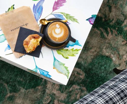 a cup of coffee and a pastry on a book at Graduate by Hilton Nashville in Nashville