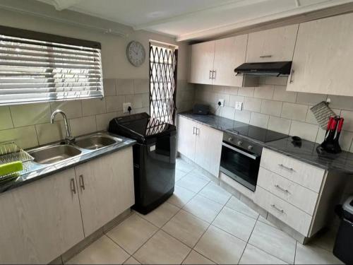 a kitchen with a sink and a stove at No 1 on Springfield in Winterton