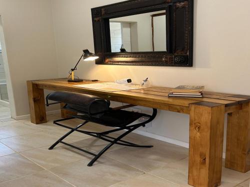 a wooden desk with a chair and a mirror at No 1 on Springfield in Winterton
