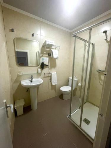 a bathroom with a sink and a toilet and a shower at Casual Gurea in Bilbao