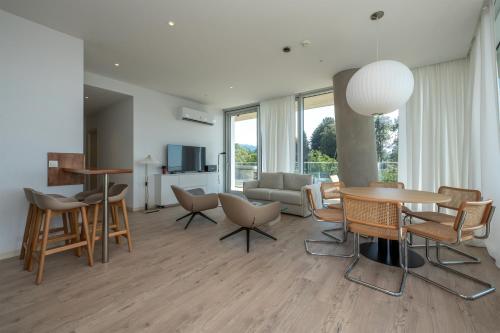 a living room with a table and chairs and a couch at Green Cape Botanico in Batumi